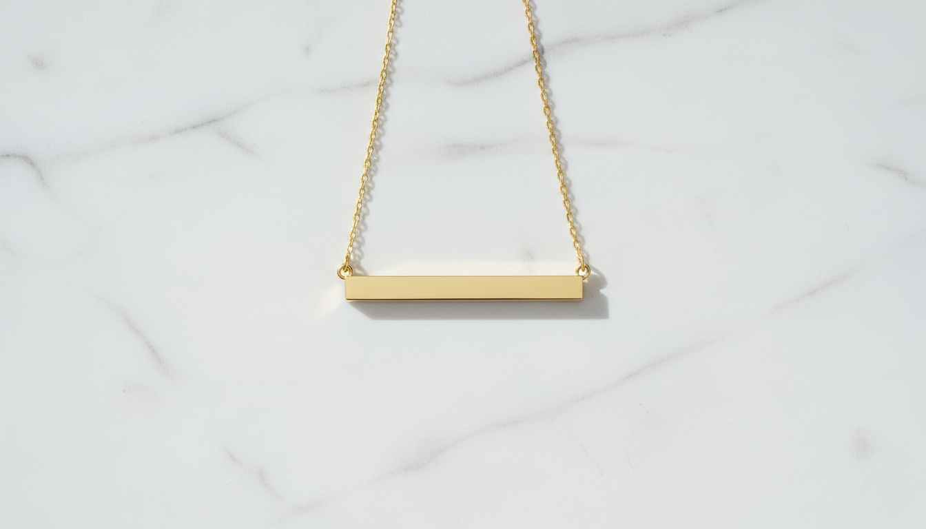 Minimalist 14k gold horizontal bar necklace on white marble — modern everyday jewelry