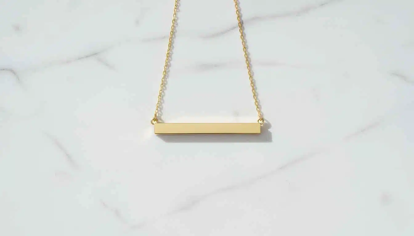 Minimalist 14k gold horizontal bar necklace on white marble — modern everyday jewelry
